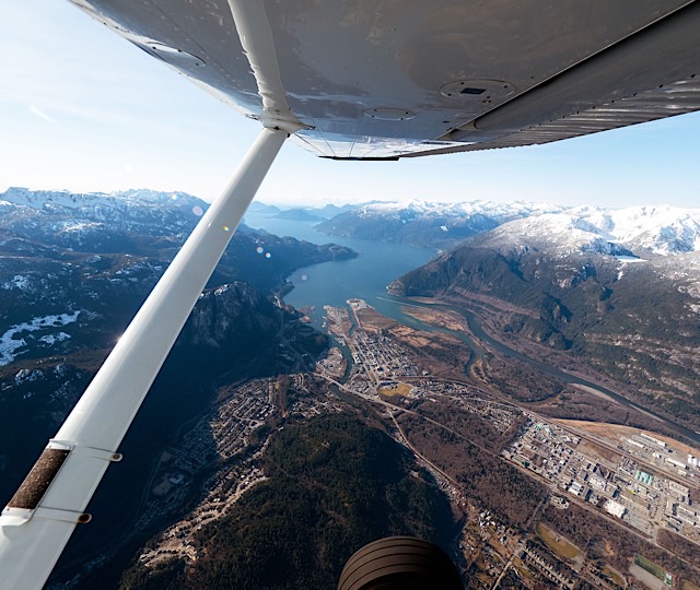 Looking out of the plane window under the wing out towards Squamish and the Howe Sound