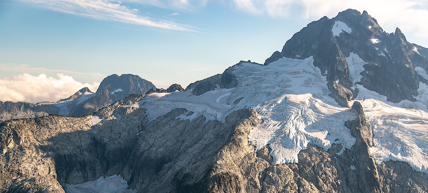 A view from the scenic flight of glaciers perched on the faces of Alpha and Omega mountains in the Tantalus Range in Squamish BC