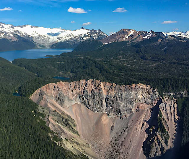 An aerial view of The Barrier dam and Garibaldi Lake in the background on a sunny day