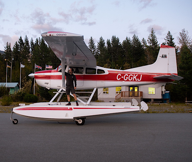 Pilot standing on the floats of an amphibious seaplane at Sea To Sky Air’s base in Squamish