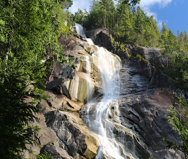 Looking up from the bottom of Shannon Falls Squamish on a summer day