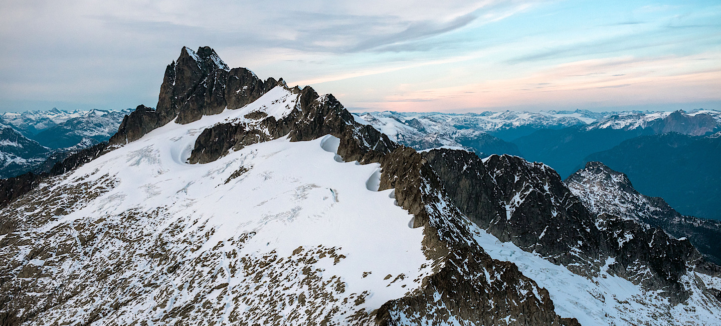 Ridge line of a mountain in the Tantalus Range, Squamish poking through the glacier ice on a summer day